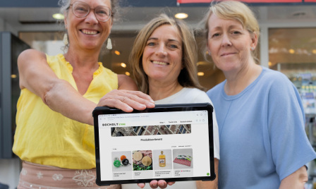 Staff from the Bocholt Tourist Information Centre demonstrate a tablet with an online shop outside their high-street shop on Nordstraße Staff from the Bocholt Tourist Information Centre demonstrate a tablet with an online shop outside their high-street shop on Nordstraße