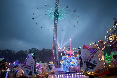 Carousels at dusk on Berliner Platz