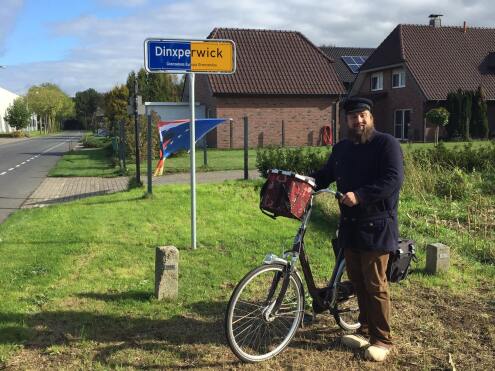 Bocholt night watchman in front of Dinxperwick town sign