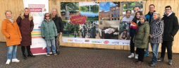  Organisers and participants in front of the construction fence banner with the photos of the \